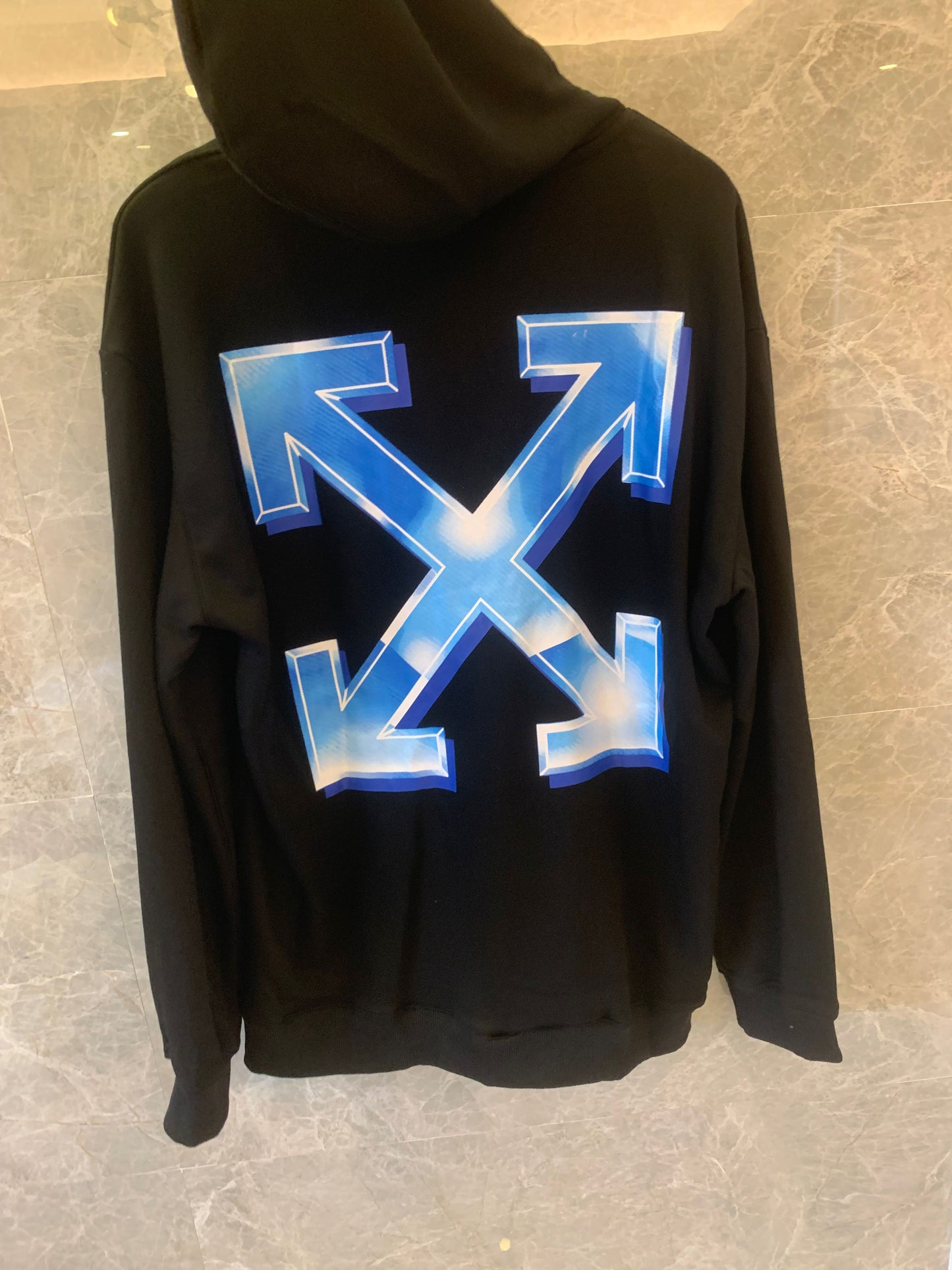 Off-White black hoodie with blue gradient logo and arrows