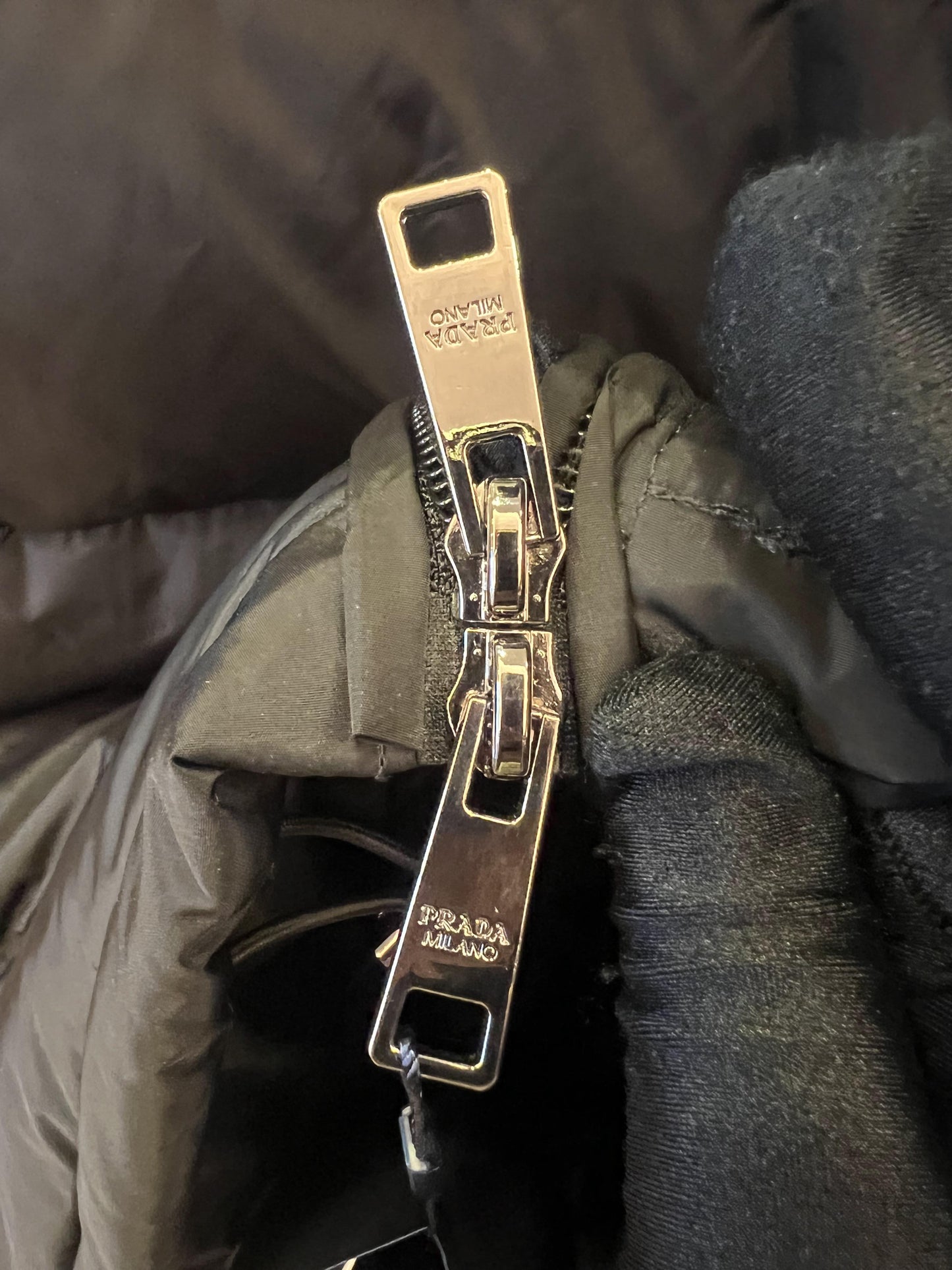 Prada down jacket with fur-trimmed hood in black