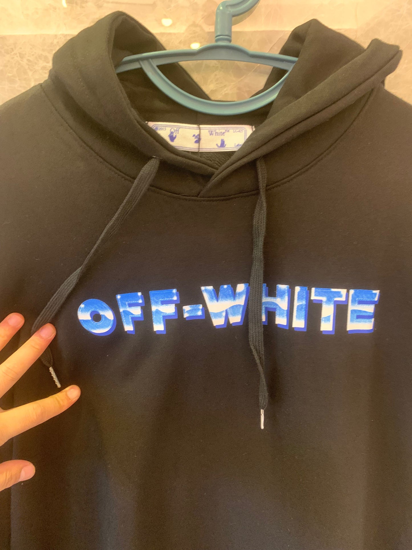 Off-White black hoodie with blue gradient logo and arrows