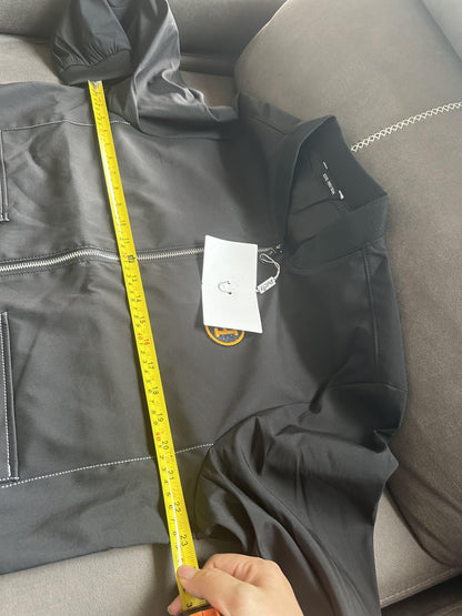 Chaqueta bomber de nailon negra de Hermès con parche del logotipo "H" amarillo.