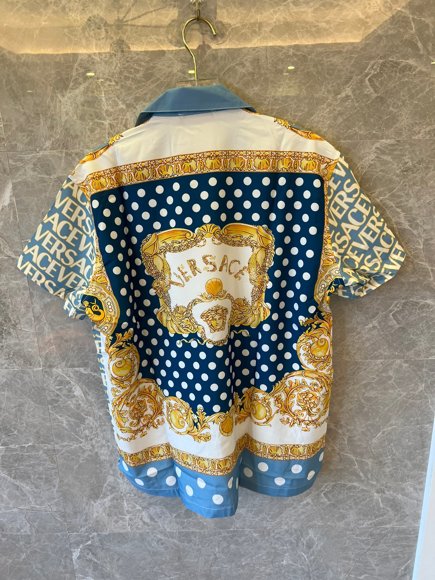 Camisa de manga corta con botones y estampado barroco de lunares azules de Versace