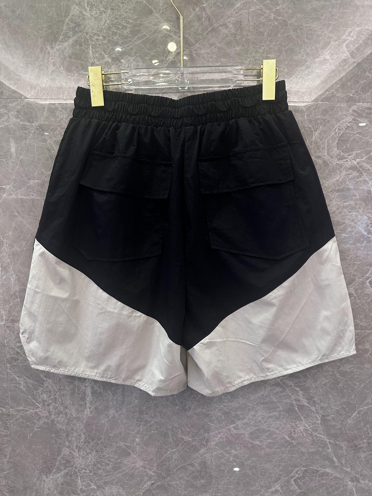 Rhude black and white logo shorts with yellow drawstring and zipper detail