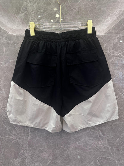 Rhude black and white logo shorts with yellow drawstring and zipper detail