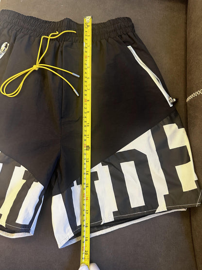 Rhude black and white logo shorts with yellow drawstring and zipper detail