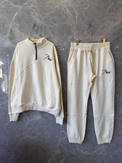 Conjunto de chándal Rhude color crema con bordado característico
