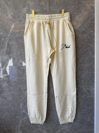 Conjunto de chándal Rhude color crema con bordado característico
