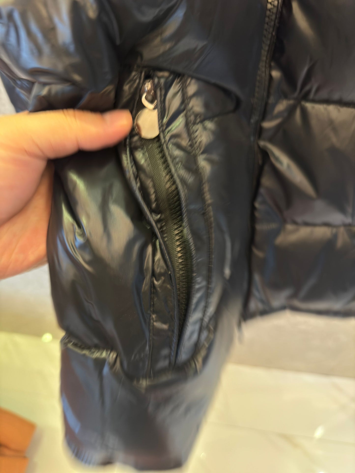 Chaqueta acolchada negra brillante de Prada con diseño de capucha