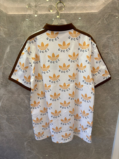 Polo con estampado de trébol de Gucci x Adidas en blanco y marrón con logotipos icónicos