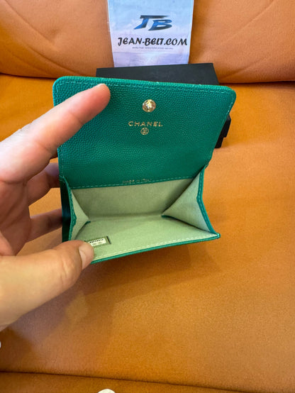 Cartera clásica con solapa de Chanel: piel caviar verde esmeralda con logo CC dorado.