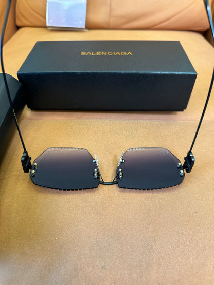Balenciaga BB0174Q 007T Rimless Sunglasses – Black Studded Shield Sesign